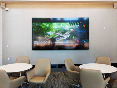 NCI provides audio/visual installation. Indoor room with seats, table and a TV.