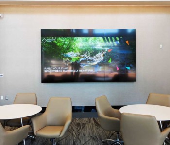 Indoor room with seats, table and a TV.